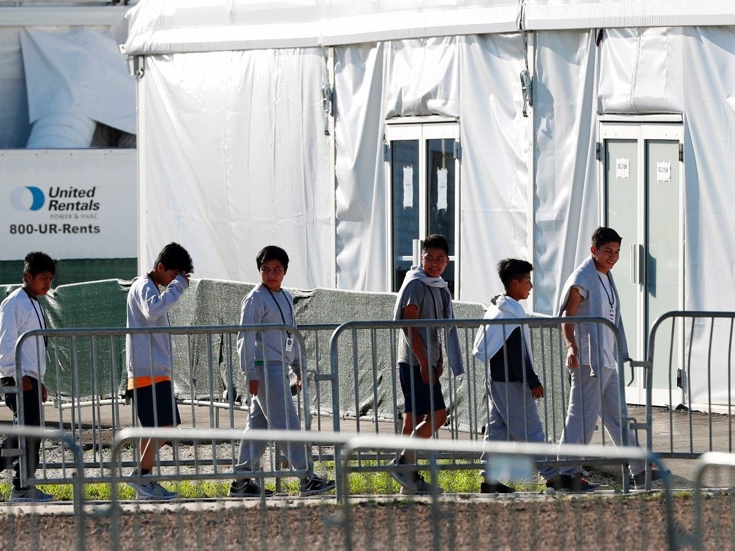 Children line up to enter a tent at the Homestead Temporary Shelter for Unaccompanied Children in Homestead, Florida.