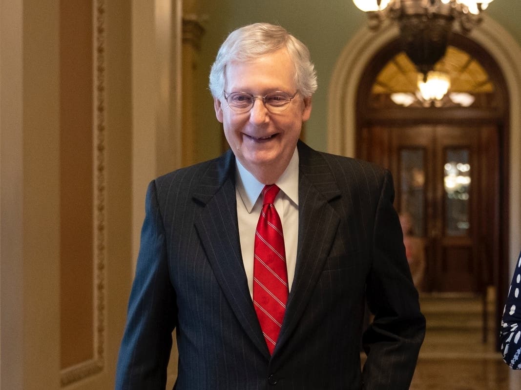 Senate Majority Leader Mitch McConnell, R-Ky., smiles after vote on a hard-won budget deal that would permit the government to resume borrowing to pay all of its obligations and would remove the prospect of a government shutdown in October.