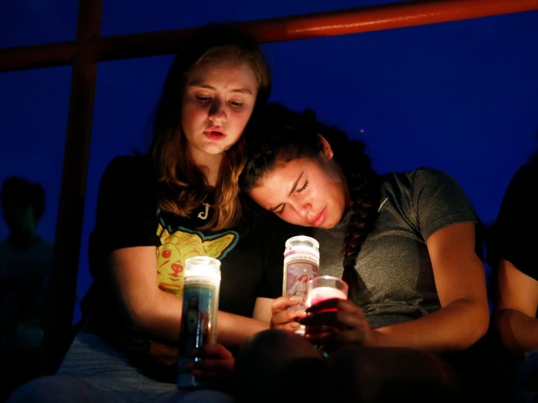 Melody Stout and Hannah Payan comfort each other during a vigil for victims of the shooting that occurred earlier in the day at a shopping center, Saturday, Aug. 3, 2019, in El Paso, Texas. 