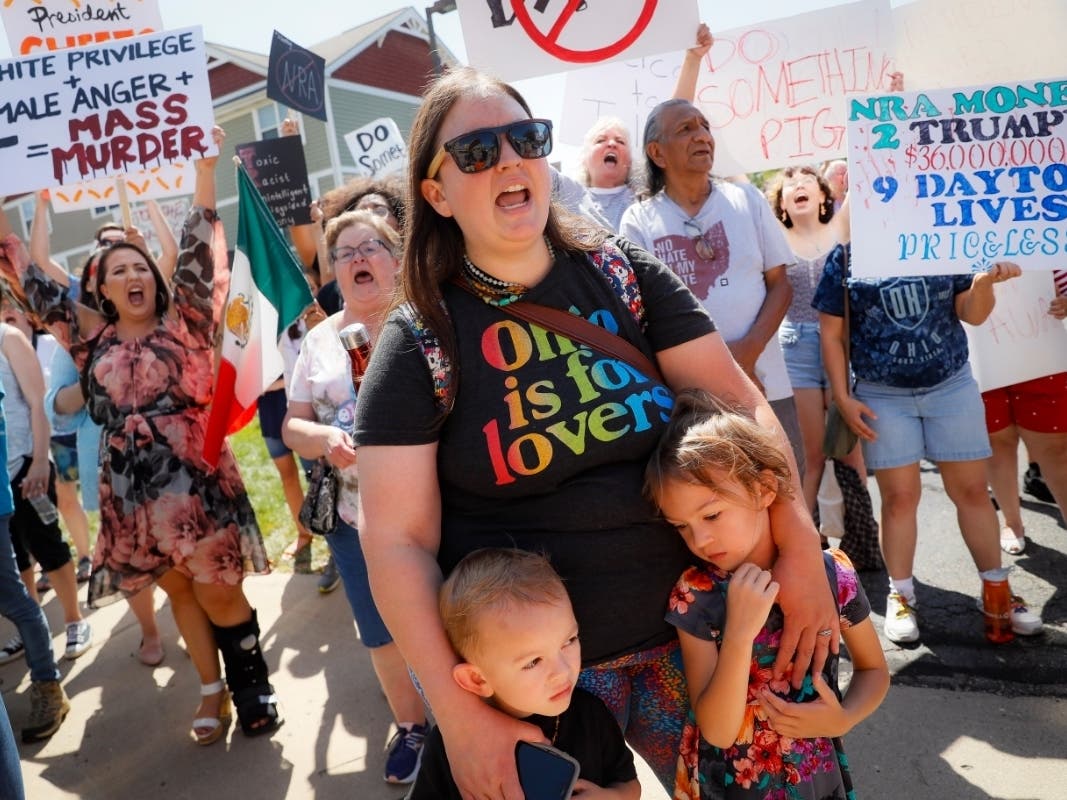 Demonstrators chant as they protest the arrival of President Donald Trump Wednesday outside Miami Valley Hospital after a mass shooting Sunday in the Oregon District early Sunday morning.
