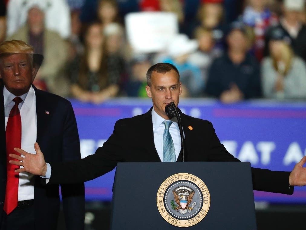 President Donald Trump watches as Corey Lewandowski, his former campaign manager, speaks during a campaign rally in Washington Township, Mich., Saturday, April 28, 2018.