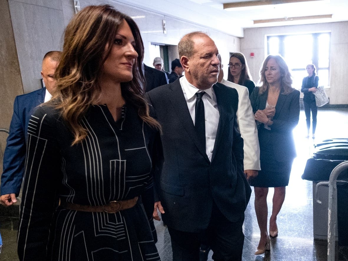 Harvey Weinstein, center, appears in a courthouse for a scheduled arraignment Monday, Aug. 26, 2019.
