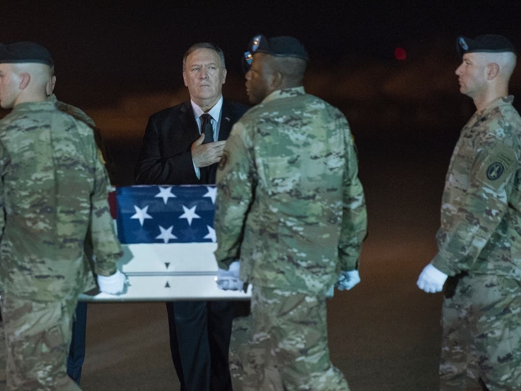An Army carry team moves a transfer case containing the remains of Sgt. 1st Class Elis Barreto Ortiz, 34, from Morovis, Puerto Rico, past Secretary of State Mike Pompeo, Saturday, Sept. 7, 2019,.