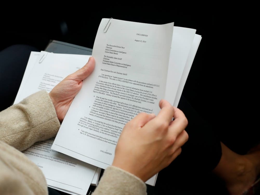 A member of the audience holds a copy of the Whistle-Blower Complaint letter sent to Senate and House Intelligence Committees during testimony by Acting Director of National Intelligence Joseph Maguire before the House Intelligence Committee.