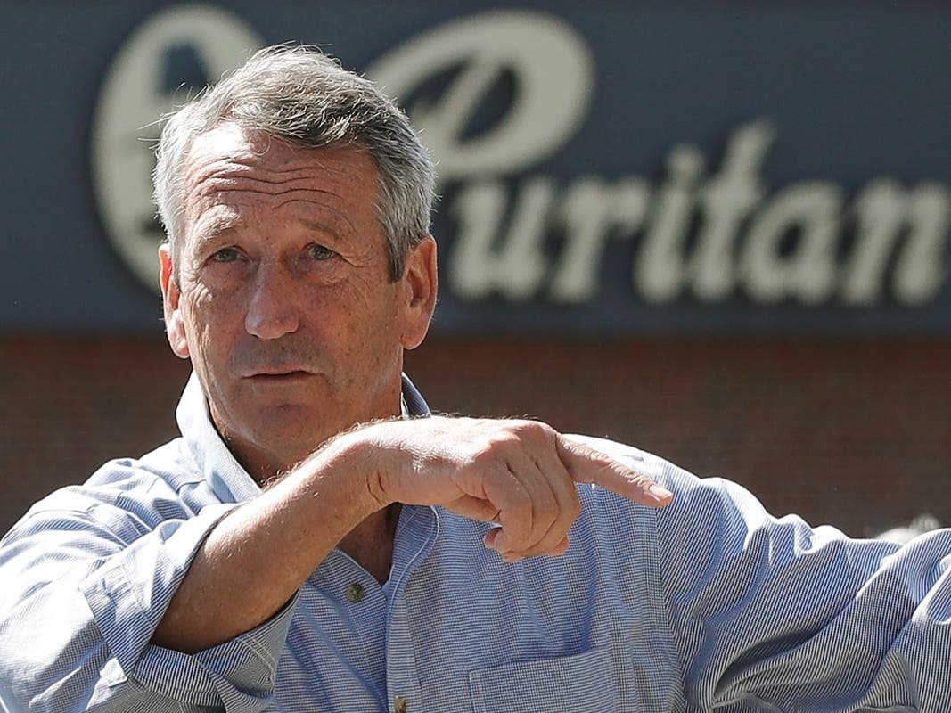 Republican presidential candidate, former South Carolina Gov. Mark Sanford speaks to a campaign aide in the parking lot of the Puritan Backroom restaurant, during a campaign stop, Thursday, Sept. 19, 2019, in Manchester, N.H.