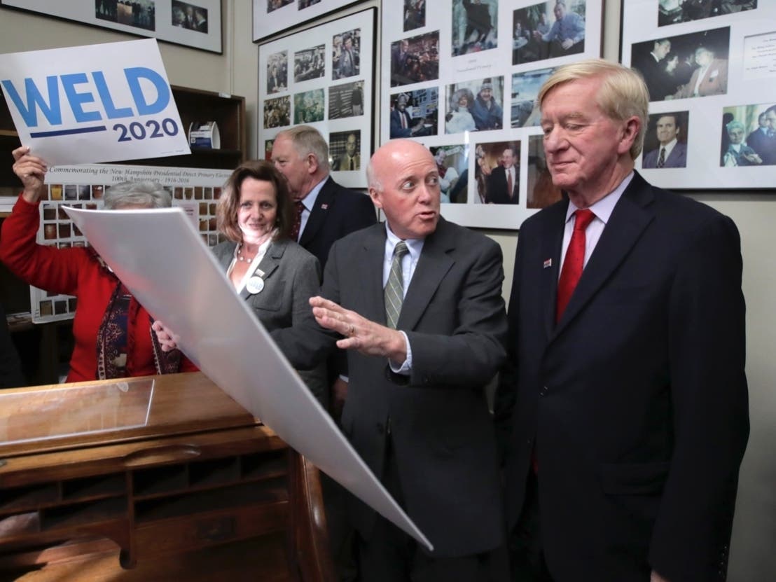 Republican presidential candidate former Massachusetts Gov. William Weld, right, looks at a poster about the history of the New Hampshire primary with Secretary of State Bill Gardner as he files to have his name listed on the New Hampshire primary ballot.