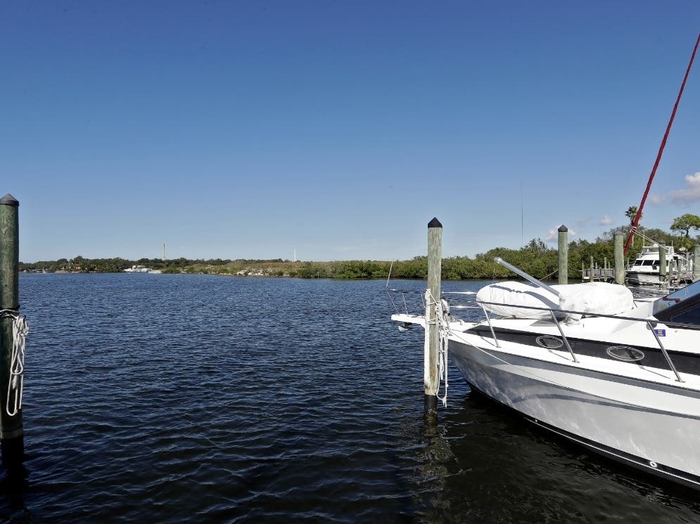 Boats are shown moored in the Anclote River near the old Stauffer chemical plant site in Tarpon Springs, Florida, one of 945 U.S. Superfund sites a Government Accountability Office says is vulnerable to weather extremes like hurricanes or wildfires.