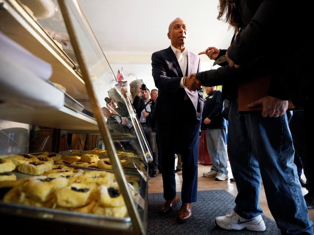 Former Massachusetts Gov. Deval Patrick talks to local residents Monday after placing his order at the Sykora Bakery in Cedar Rapids, Iowa, after entering the Democratic presidential race last week. 