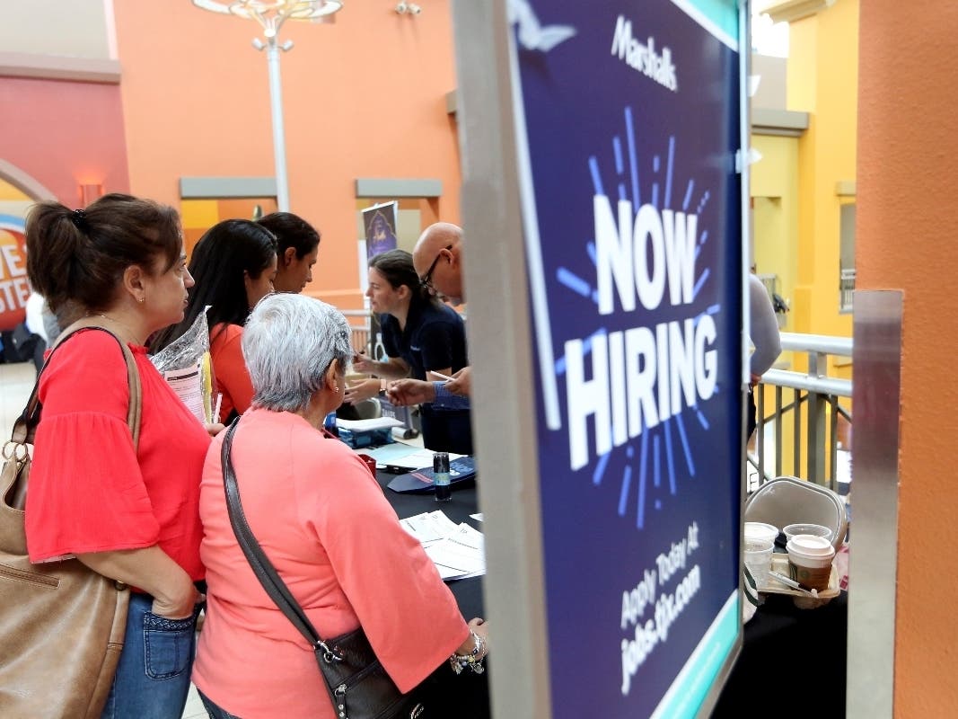 Job seekers wait in line to inquire about open positions with Marshalls during a job fair Oct. 1 at Dolphin Mall in Miami.
