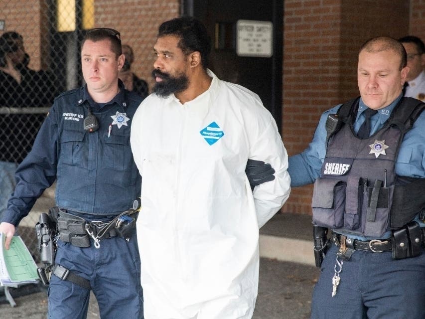 Ramapo police officers escort Grafton Thomas from Ramapo Town Hall to a police vehicle, Sunday, Dec. 29, 2019, in Ramapo, N.Y. Thomas is accused of stabbing multiple people as they gathered to celebrate Hanukkah.