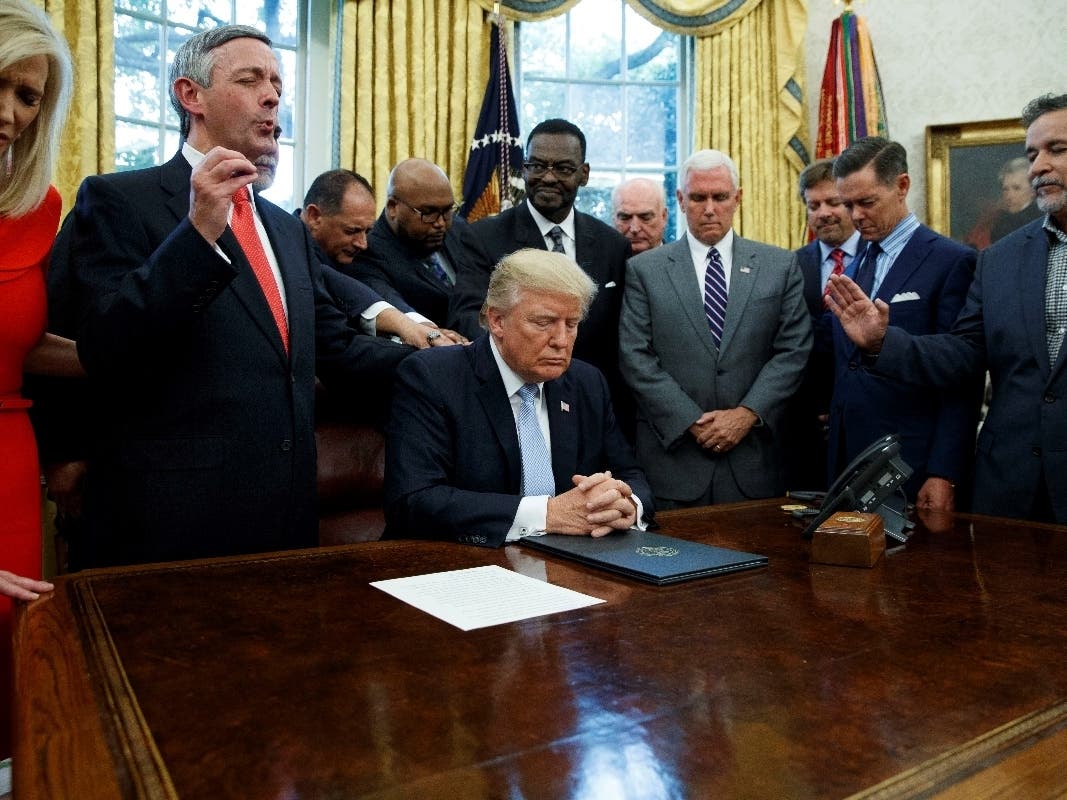 Religious leaders pray with President Donald Trump after he signed a proclamation Sept. 1, 2017, for a national day of prayer to occur on Sunday, Sept. 3, 2017.