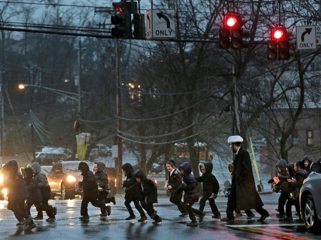 Orthodox Jewish children cross the street Monday in Monsey, N.Y. With the rapid expansion of Orthodox communities outside New York City has come civic sparring, and some fear the recent violence in the area may be an outgrowth of that conflict. 