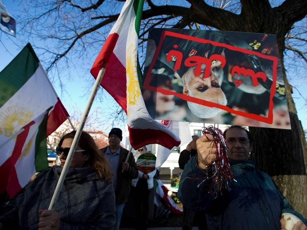 Members of the Iranian American community of Washington, D.C., who support an Iranian exile group that seeks to overthrow Iran’s government rally Monday outside the State Department in Washington.