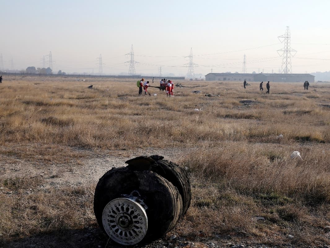 Debris is seen from an Ukrainian plane that crashed Wednesday, as rescue workers search the scene in Shahedshahr, southwest of the capital Tehran, Iran. 