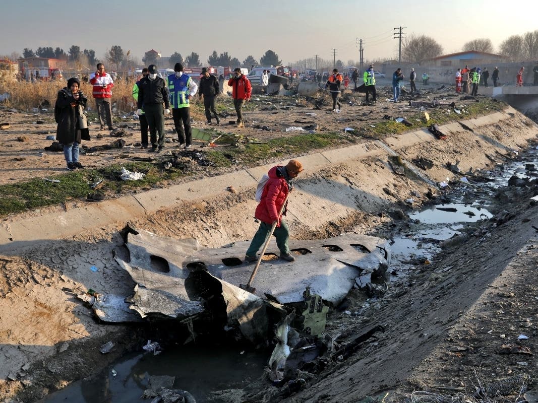 Rescue workers inspect the scene where a Ukrainian plane crashed in Shahedshahr, southwest of the capital Tehran, Iran, Wednesday, Jan. 8, 2020.