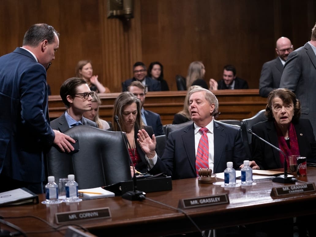 Senate Judiciary Committee Chairman Lindsey Graham of South Carolina, right, speaks with Utah GOP Sen. Mike Lee, a member of the panel, who criticized a security briefing on Iran probably the worst briefing I've seen, at least on a military issue."