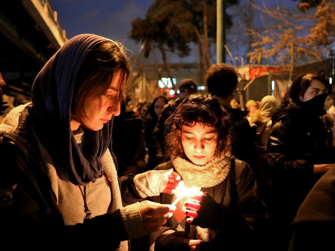 People gather Saturday for a candlelight vigil in Tehran, Iran, to remember the victims of the Ukraine plane crash. The vigil took place at the gate of Amri Kabir University, where some of the crash victims had been students.
