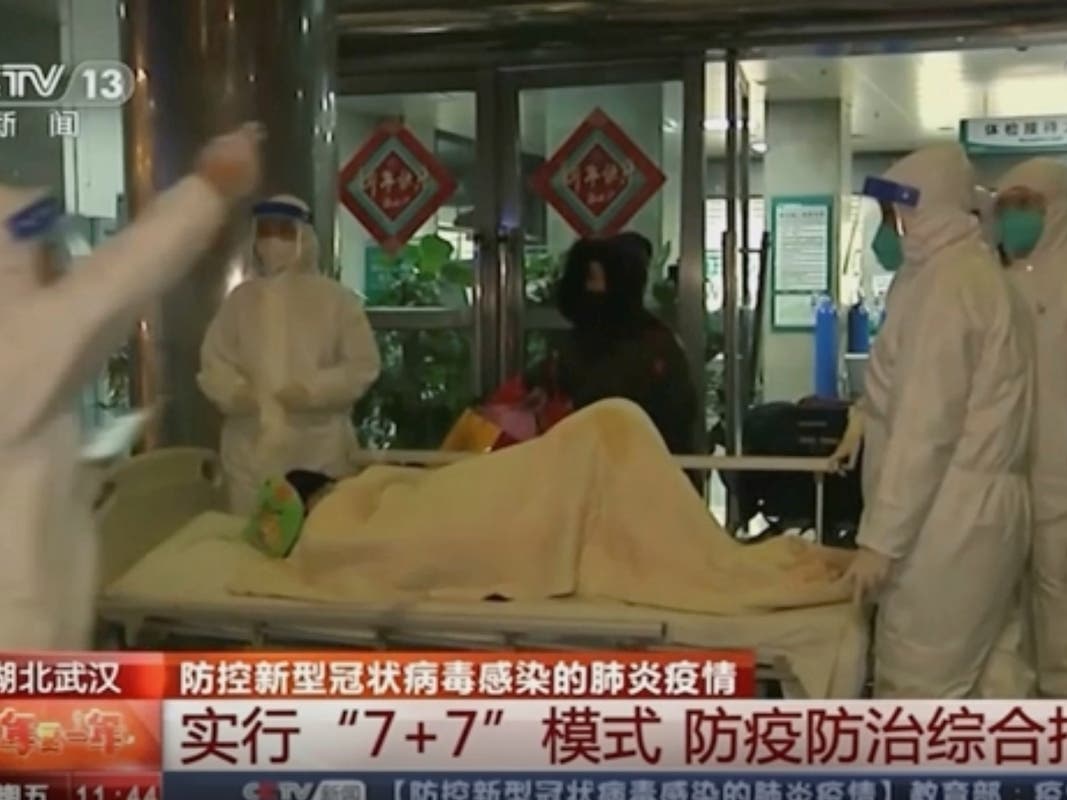 A patient is carried on a stretcher Thursday to an ambulance by medical workers in protective suits in Wuhan, China. 