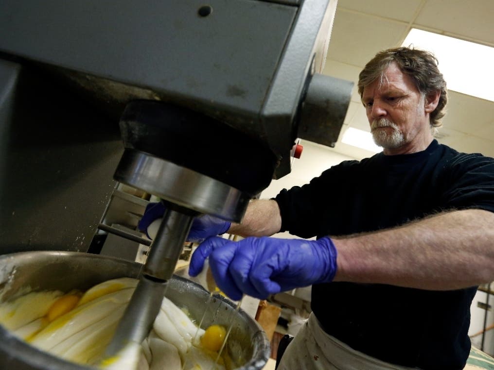 FILE - In this March 10, 2014 file photo, Masterpiece Cakeshop owner Jack Phillips cracks eggs into a cake batter mixer inside his store in Lakewood.