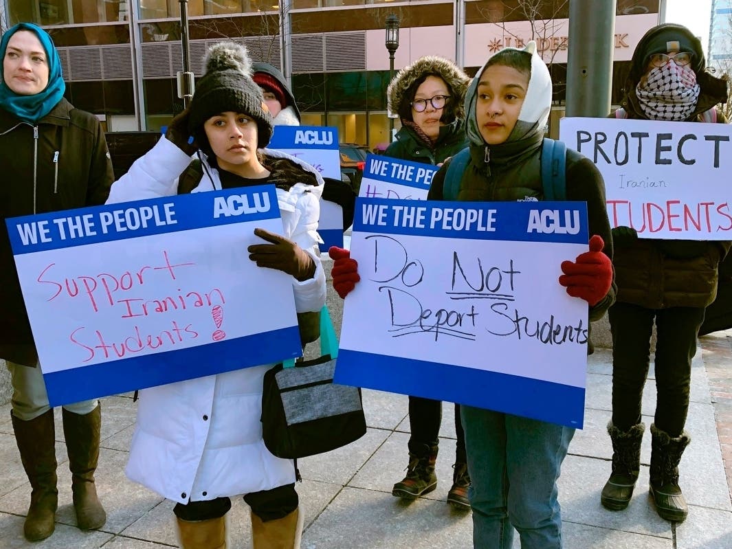 Protesters stand outside the federal courthouse where a hearing was scheduled for Northeastern University student Shahab Dehghani Jan. 21.