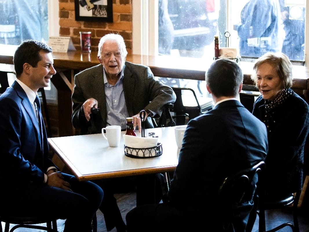 Pete Buttigieg (left) and his husband, Chasten Buttigieg (second from the right) meet Sunday with former President Jimmy Carter and former first lady Rosalynn Carter at the Buffalo Cafe in Plains, Georgia.