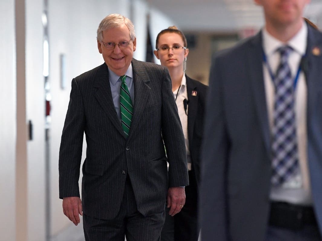 Senate Majority Leader Mitch McConnell walks to attend a Republican policy lunch on Capitol Hill in Washington Thursday.