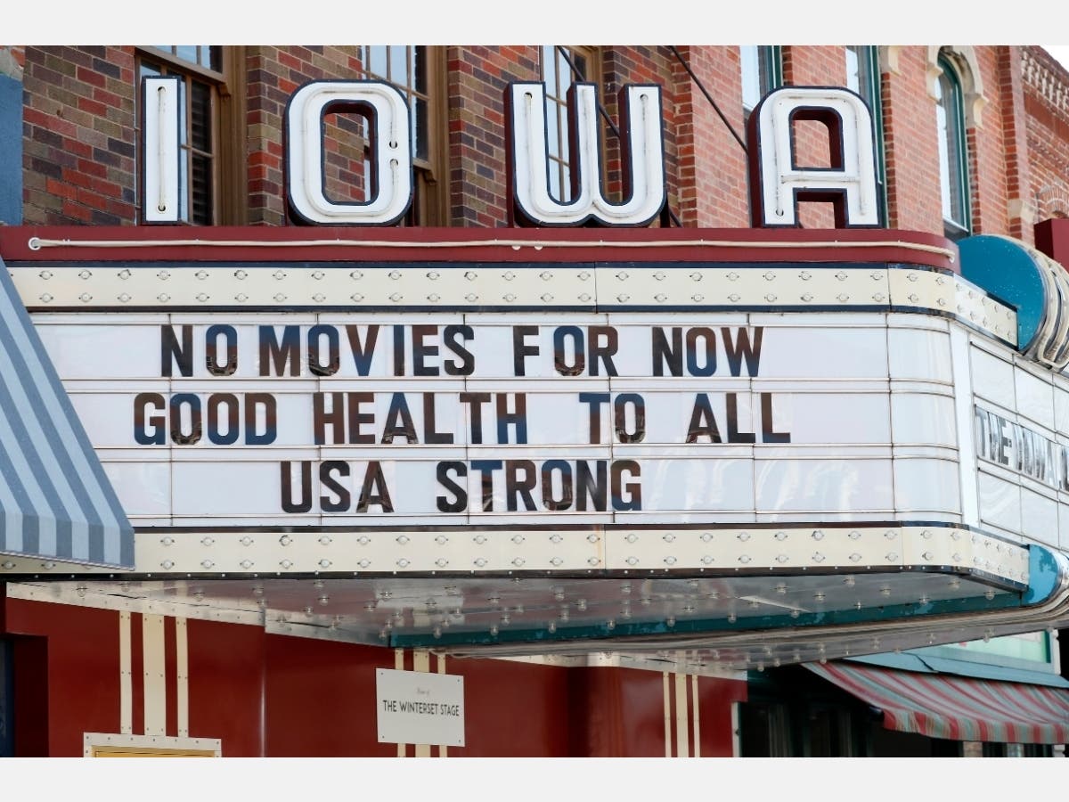 This April 1 file photo shows the marquee for the Iowa Theater in Winterset, Iowa, closed in response to the COVID-19 coronavirus outbreak. The $349 billion program approved by Congress to help small businesses opened Friday.