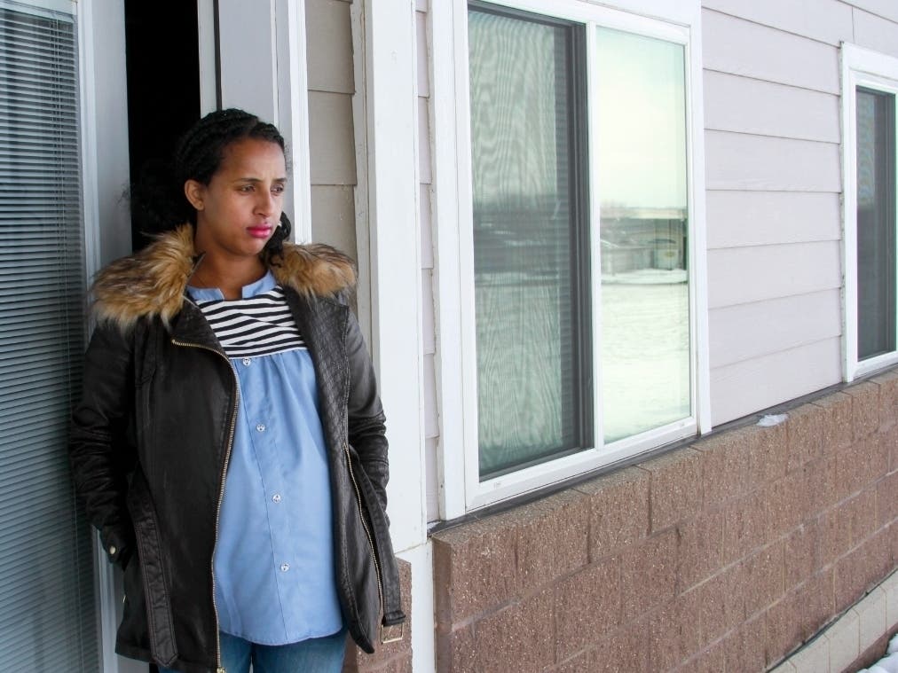 Kulule Amosa steps out of the apartment she shares with her husband who works at the Smithfield Foods pork processing plant in Sioux Falls, South Dakota. He tested positive for the coronavirus this week after an outbreak at the plant.