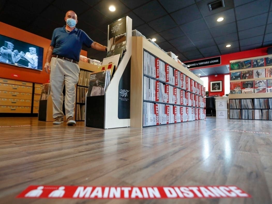 Mark Mawhinney prepares his store to reopen Friday when some of the coronavirus restrictions will be lessened in Pittsburgh and several western Pennsylvania counties.