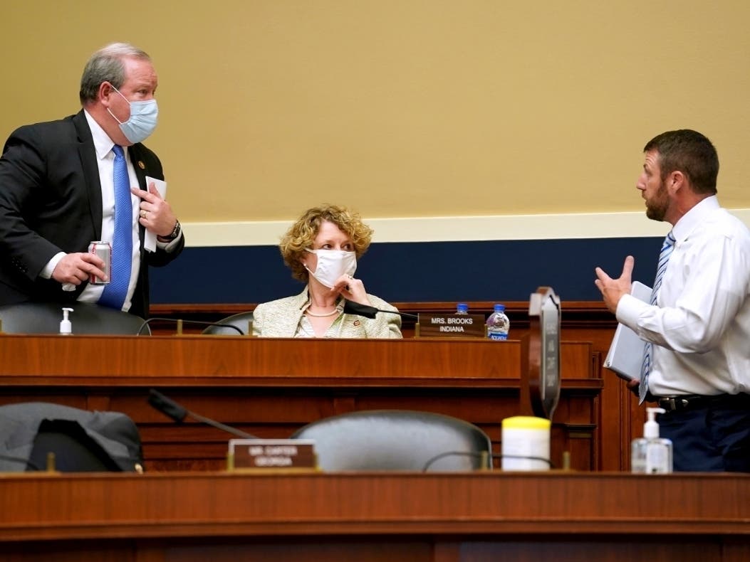 Rep. Larry Bucshon, R-Ind., right, speaks to Reps. Susan Brooks, R-Ind., and Markwayne Mullin. R-Okla., during a House subcommittee meeting.