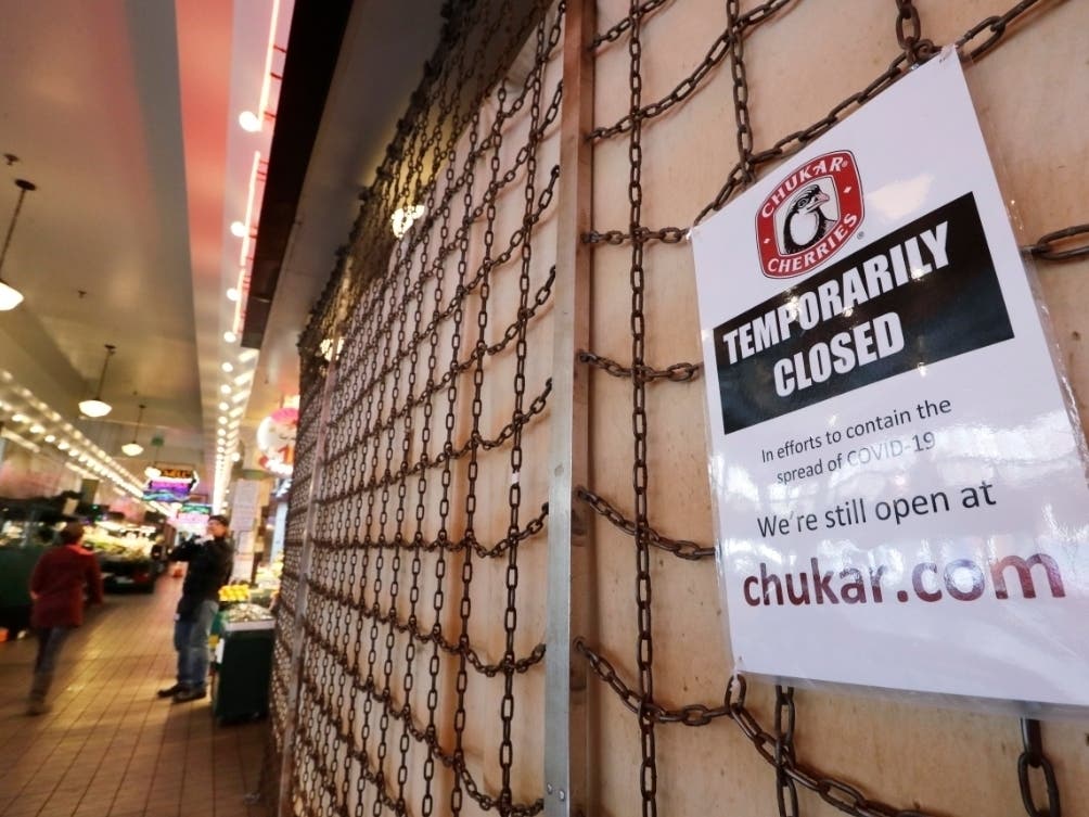 The a shop at the Pike Place market in Seattle remains shuttered because of the coronavirus, which has caused record numbers of Americans to seek unemployment benefits.