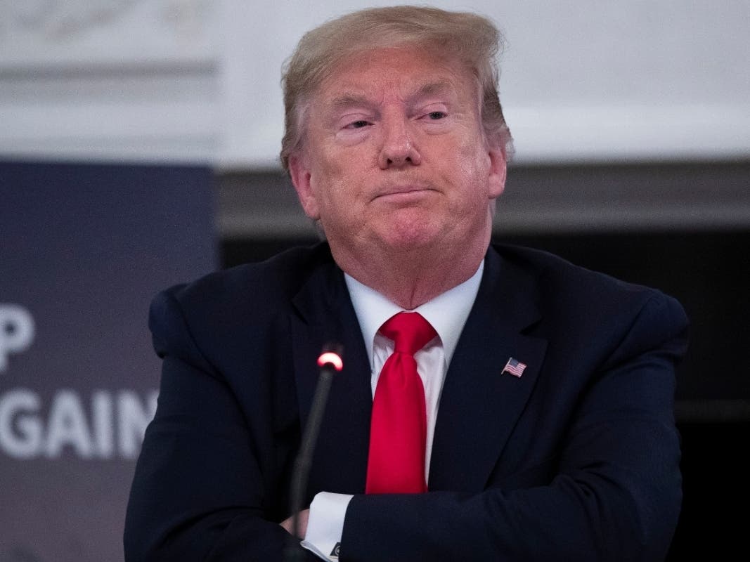 President Donald Trump listens during a roundtable with industry executives about reopening the country after the coronavirus closures.
