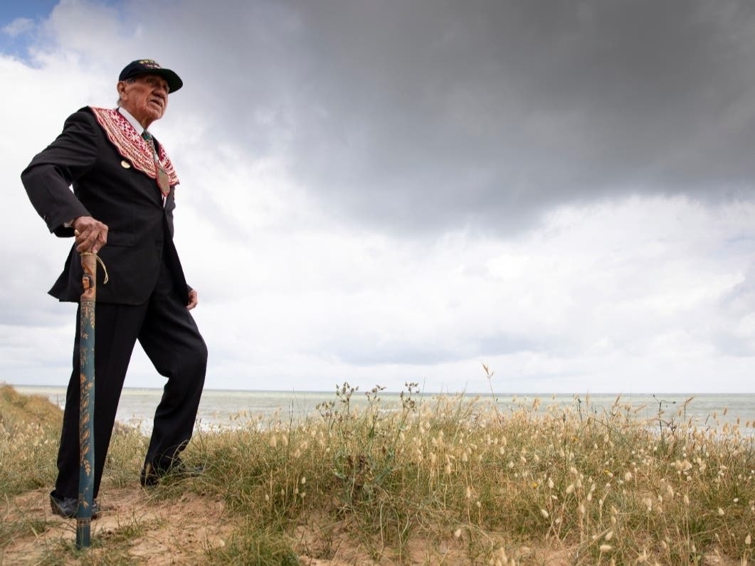 World War II D-Day veteran and Penobscot Elder from Maine, Charles Norman Shay poses on the dune overlooking Omaha Beach prior to a ceremony at his memorial in Saint-Laurent-sur-Mer, Normandy, France,