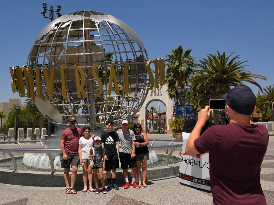 A family has their picture taken at Universal CityWalk in Universal City, California.  The tourist attraction, which had been closed due to the coronavirus outbreak recently re-opened. 