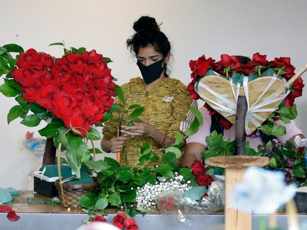 a merchant prepares a floral arrangement on Mother's Day at the Los Angeles Flower Market in Los Angeles. Americans are more unhappy today than they’ve been in nearly 50 years.