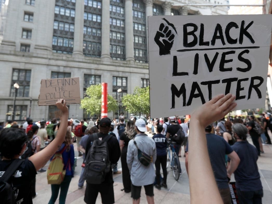 Protesters gather in Thompson Plaza, across the street from Chicago's City Hall, Wednesday, demanding that Chicago Mayor Lori Lightfoot enact the ordinance for an all-elected Civilian Police Accountability Council in Chicago