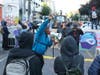 A man speaking in to a bullhorn urges protesters not to be violent after workers and heavy equipment from the Seattle Department of Transportation arrived at the the CHOP (Capitol Hill Occupied Protest) zone in Seattle, Friday, June 26, 2020.