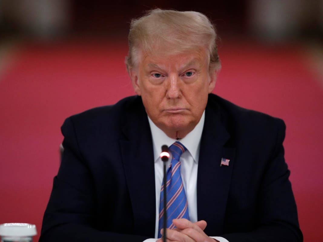 President Donald Trump listens during a "National Dialogue on Safely Reopening America's Schools" event in the East Room of the White House.