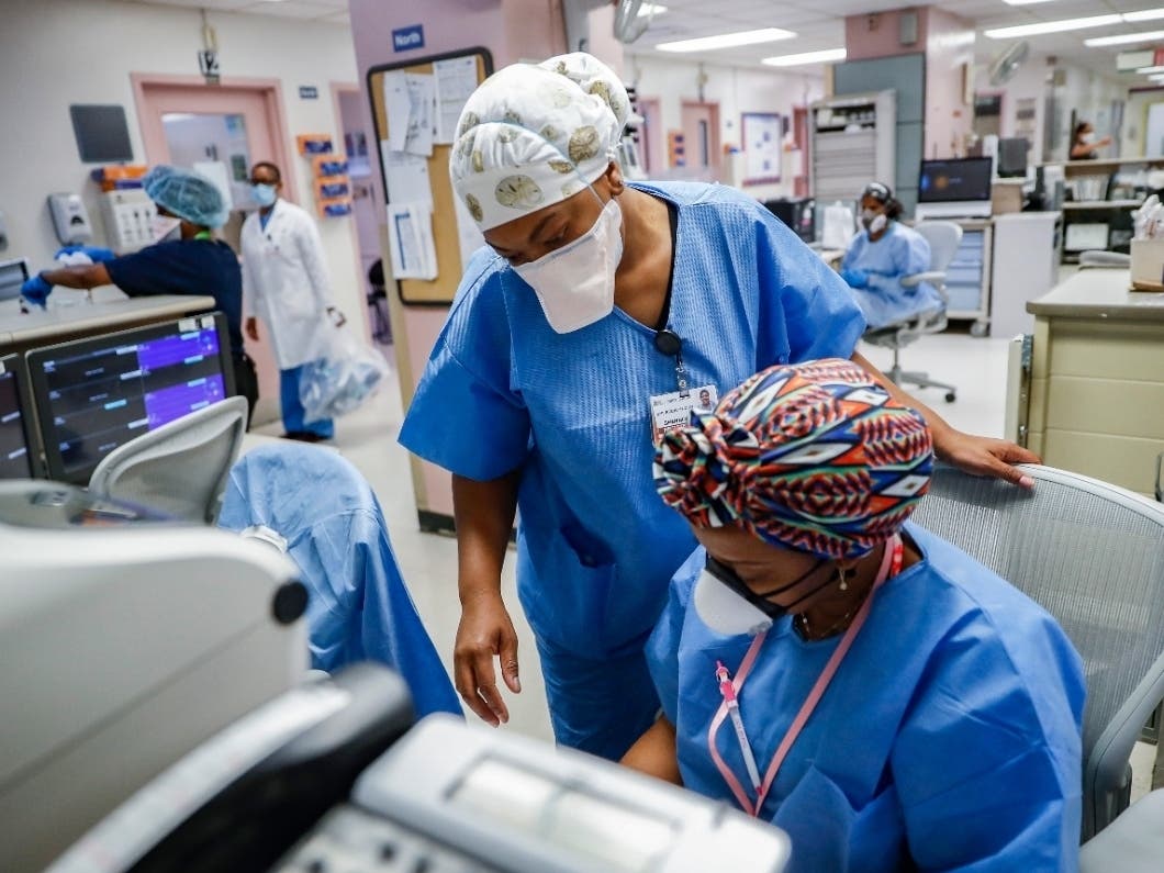 In this May 27, 2020, file photo, medical personnel work in the emergency department at NYC Health + Hospitals Metropolitan in New York. 
