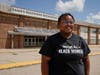 Shyra Adams stands outside James Madison Memorial High School in Madison, Wisconsin, where  Adams helps lead a parent-driven movement to get police out of her school and others.