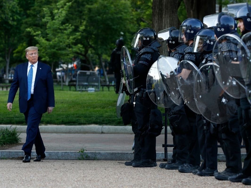 President Donald Trump walked past federal law enforcement officers in a newly cleared Lafayette Square in June. Democratic lawmakers want answers about the force deployed by some Park Police in routing protesters from the oft-used protest space.