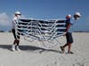 Workers remove chairs from the beach in preparation for Hurricane Isaias on Friday in Miami Beach, Fla. 