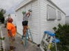 Chris Nagiewicz, left, watches as his wife Mary screws in a hurricane panel on their trailer home in Briny Breezes, Fla.