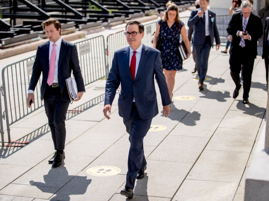 Treasury Secretary Steven Mnuchin, center, and President Donald Trump's Chief of Staff Mark Meadows, second from right, leave following a meeting Friday on coronavirus relief with House Speaker Nancy Pelosi and Senate Minority Leader Sen. Chuck Schumer.