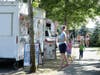 Customers line up to order from the YS Street Food food truck, Monday, Aug. 10, 2020, near the suburb of Lynnwood, Wash., north of Seattle. 