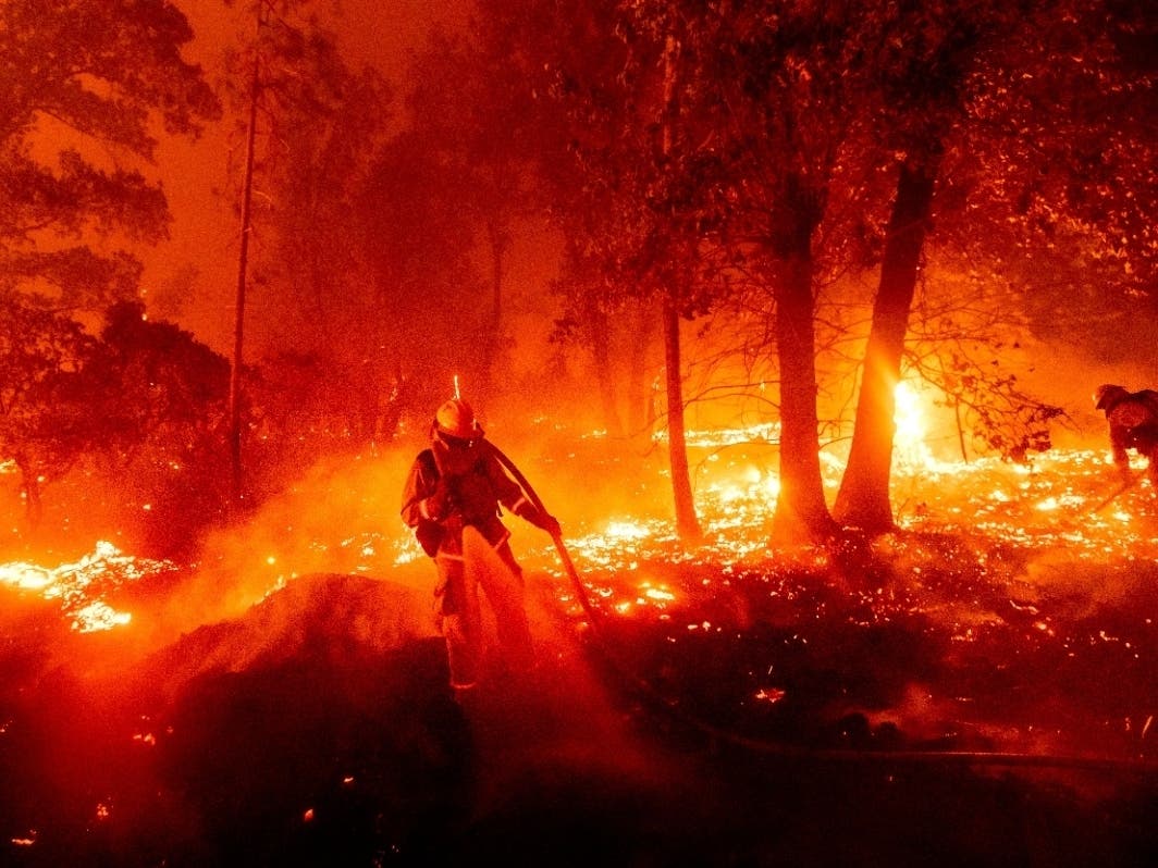 Climate DisastersIn this Sept. 7, 2020, file photo, a firefighter battles the Creek Fire as it threatens homes in the Cascadel Woods neighborhood of Madera County, Calif.