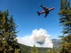 An air tanker prepares to drop retardant Sept. 17 while battling the August Complex Fire in the Mendocino National Forest, Calif. Rain showers fell Thursday on the northwestern edges of fire-ravaged California.