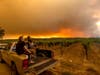 In this Aug. 20, 2020, file photo, Thomas Henney, right, and Charles Chavira watch a plume spread over Healdsburg, Calif., as the LNU Lightning Complex fires burn. 