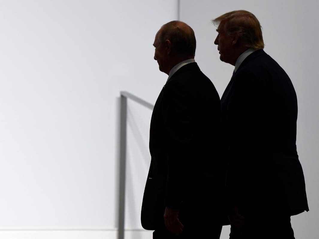 Democrats have criticized President Donald Trump for not publicly calling out Russian President Vladimir Putin for election interference or embrace the intelligence community's findings that Russia meddled in 2016. ​ The two leaders are shown in 2019.