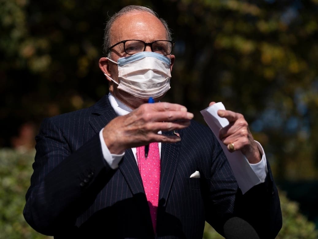 White House chief economic adviser Larry Kudlow talks with reporters outside the White House about coronavirus relief package negotiations Friday. The White House is now offering a $1.8 trillion package.